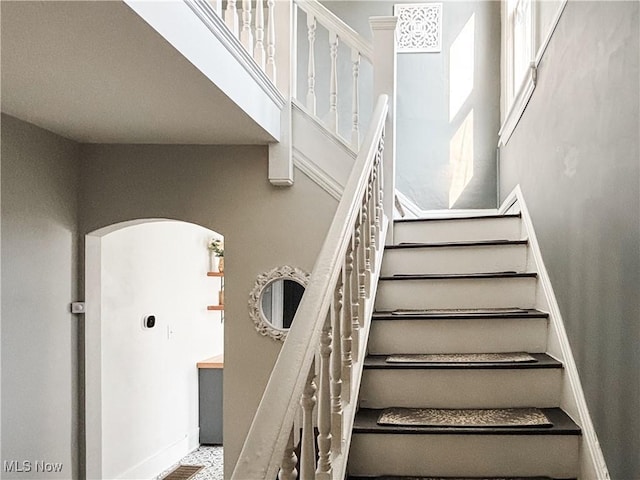 1021 12th Ave, Vienna, WV 26105 - staircase featuring baseboards and arched walkways