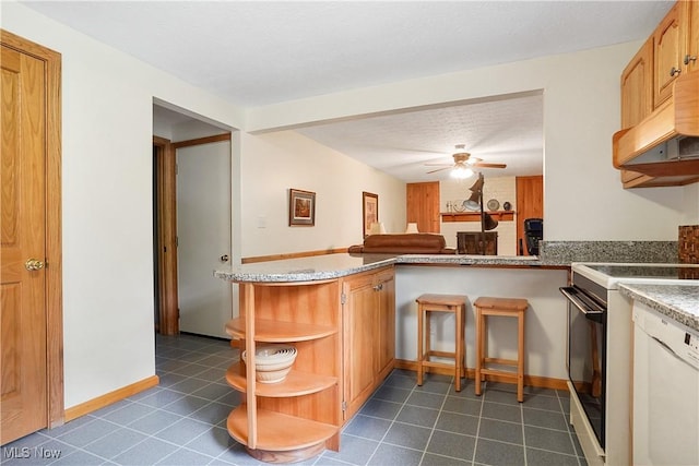 4190 Springdale Rd, Stow, OH 44224 - kitchen featuring range, open shelves, dark tile patterned floors, ceiling fan, and a peninsula