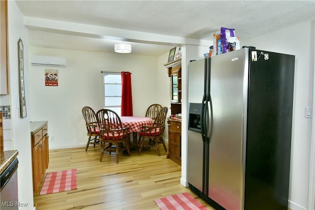 252 E Main St, Newton Falls, OH 44444 - kitchen featuring appliances with stainless steel finishes, light wood finished floors, a wall mounted air conditioner, and brown cabinetry