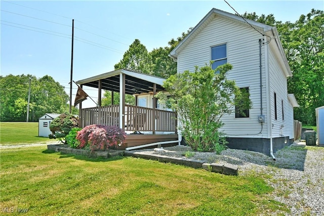 252 E Main St, Newton Falls, OH 44444 - rear view of house with a yard, a storage unit, and a wooden deck