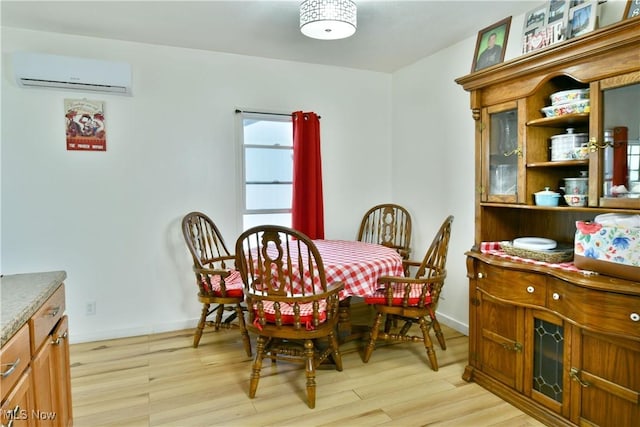 252 E Main St, Newton Falls, OH 44444 - dining room featuring a wall mounted air conditioner and light wood finished floors