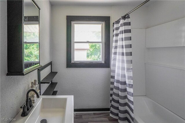 1384 Stark Ave SW, Canton, OH 44706 - bathroom featuring plenty of natural light, a textured wall, shower / bath combo with shower curtain, and vanity