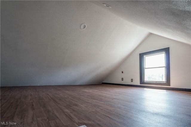 1384 Stark Ave SW, Canton, OH 44706 - additional living space featuring vaulted ceiling, dark wood-style floors, and a textured ceiling