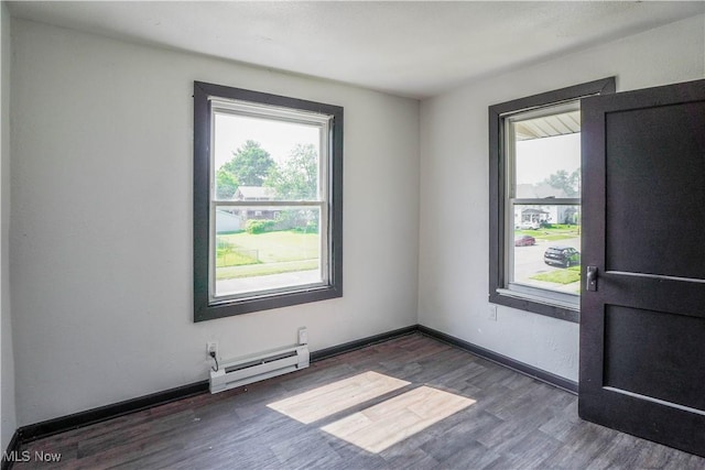 1384 Stark Ave SW, Canton, OH 44706 - empty room with baseboard heating, plenty of natural light, and wood finished floors