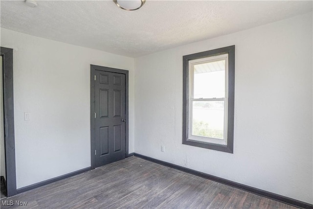1384 Stark Ave SW, Canton, OH 44706 - empty room with wood finished floors and a textured ceiling