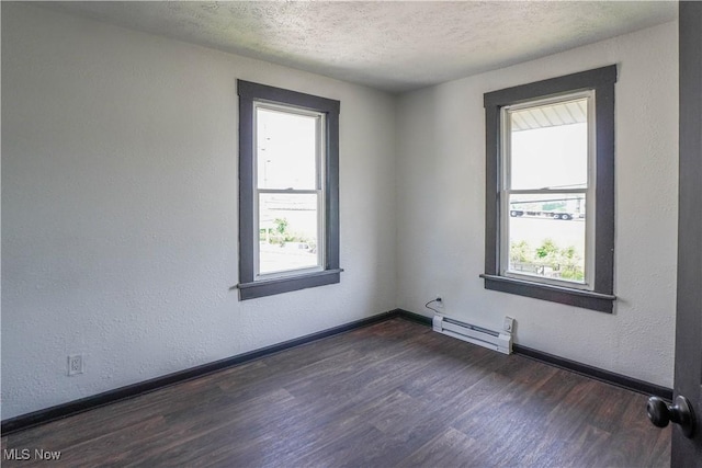1384 Stark Ave SW, Canton, OH 44706 - spare room with a baseboard heating unit, dark wood-style flooring, and a textured ceiling