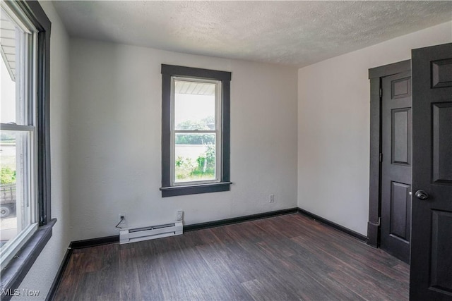 1384 Stark Ave SW, Canton, OH 44706 - spare room with a baseboard heating unit, dark wood-style flooring, and a textured ceiling
