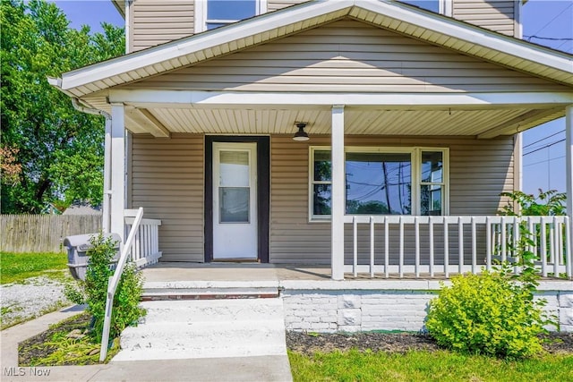 1384 Stark Ave SW, Canton, OH 44706 - view of exterior entry featuring a porch and a chimney