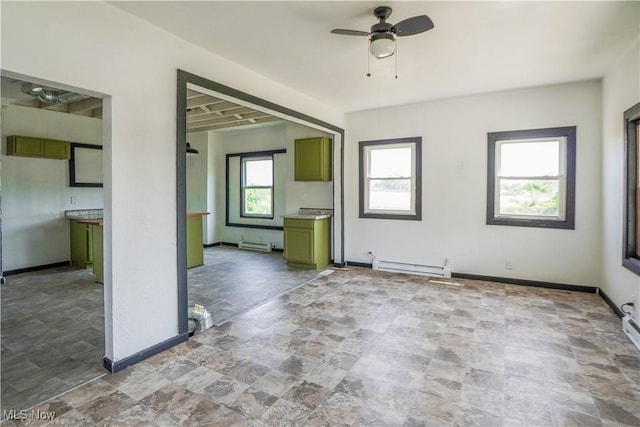 1384 Stark Ave SW, Canton, OH 44706 - unfurnished living room featuring stone finish floors, a ceiling fan, and baseboard heating