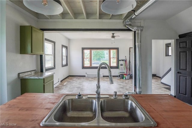 1384 Stark Ave SW, Canton, OH 44706 - kitchen with green cabinetry, butcher block counters, and a baseboard radiator