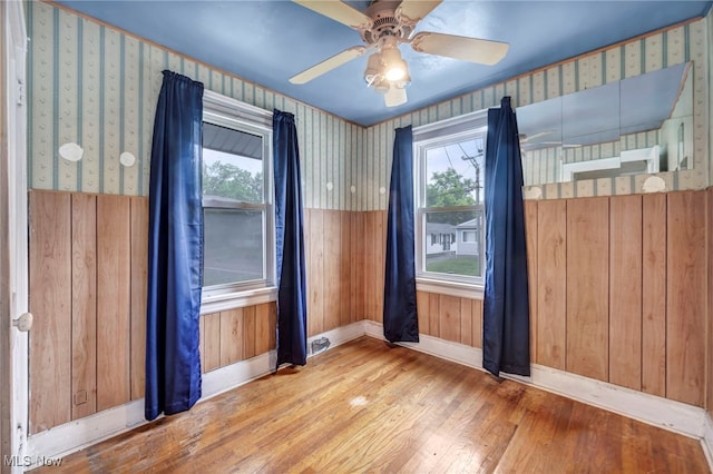 654 Van Everett Ave, Akron, OH 44306 - spare room featuring wood finished floors, healthy amount of natural light, and wallpapered walls