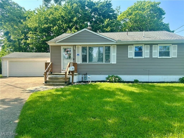 556 Moherman Ave, Youngstown, OH 44509 - view of front of property featuring a detached garage, a front yard, and a shingled roof