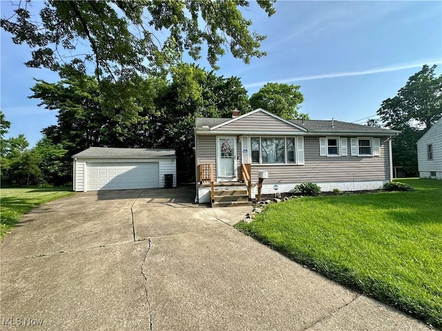 556 Moherman Ave, Youngstown, OH 44509 - view of front of home featuring an outdoor structure, a garage, a front yard, and a chimney