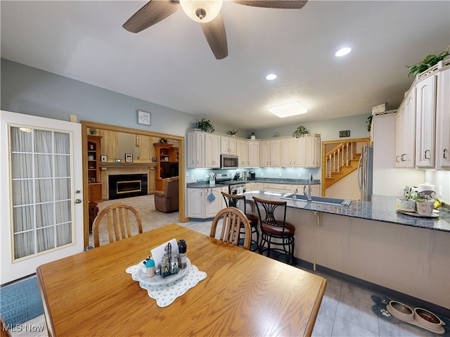 35005 Lisle Ct, Willoughby, OH 44094 - dining area with ceiling fan, a fireplace, recessed lighting, and light tile patterned floors
