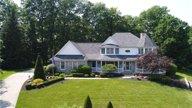 35005 Lisle Ct, Willoughby, OH 44094 - view of front of home featuring a porch, a front lawn, stone siding, and a chimney