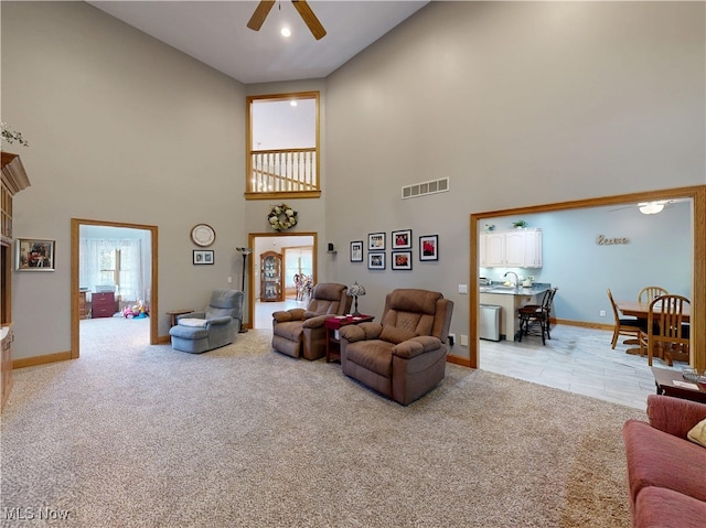 35005 Lisle Ct, Willoughby, OH 44094 - living area featuring ceiling fan, a high ceiling, and light carpet