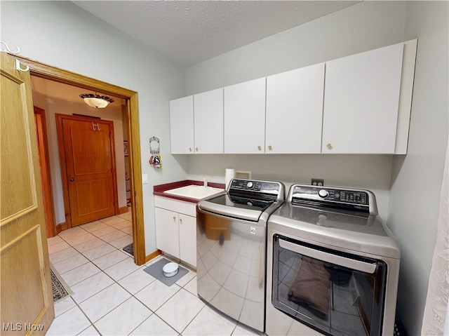 35005 Lisle Ct, Willoughby, OH 44094 - laundry room with cabinet space, independent washer and dryer, light tile patterned flooring, and a textured ceiling