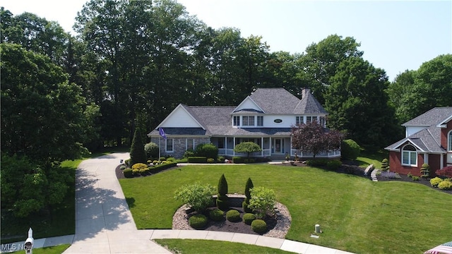 35005 Lisle Ct, Willoughby, OH 44094 - view of front of property with a front lawn, driveway, a porch, and a chimney