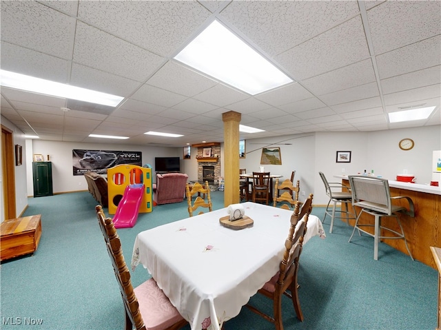35005 Lisle Ct, Willoughby, OH 44094 - carpeted dining area with a drop ceiling and a stone fireplace
