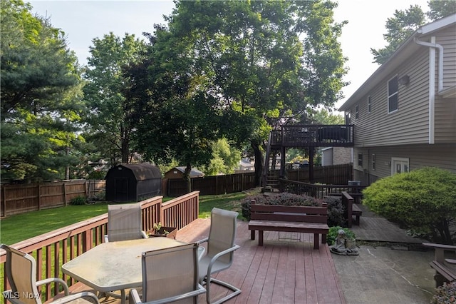 3247 Brooklawn Dr, Norton, OH 44203 - wooden deck with a shed, a fenced backyard, outdoor dining space, and grilling area
