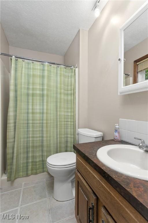 3247 Brooklawn Dr, Norton, OH 44203 - full bathroom featuring vanity, a textured ceiling, tile patterned flooring, and curtained shower