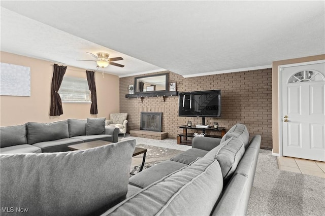3247 Brooklawn Dr, Norton, OH 44203 - tiled living area with brick wall, a fireplace, ceiling fan, and ornamental molding