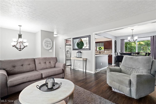 3247 Brooklawn Dr, Norton, OH 44203 - living room featuring a chandelier, dark wood finished floors, and a textured ceiling