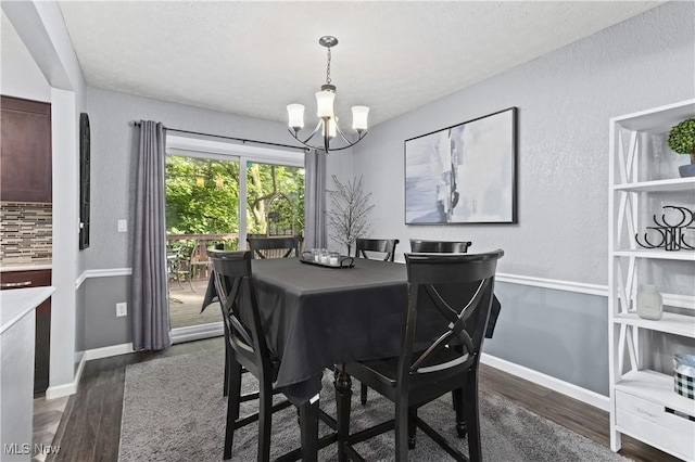 3247 Brooklawn Dr, Norton, OH 44203 - dining area with dark wood-style floors, a chandelier, a textured ceiling, and a textured wall