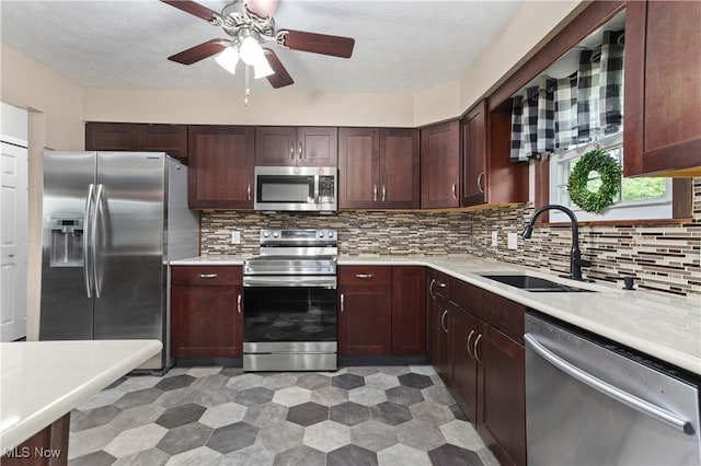 3247 Brooklawn Dr, Norton, OH 44203 - kitchen with appliances with stainless steel finishes, light countertops, ceiling fan, backsplash, and a textured ceiling