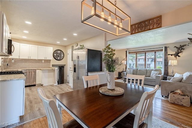 2880 Hetzel Dr, Parma, OH 44134 - dining area with light wood-style flooring and recessed lighting