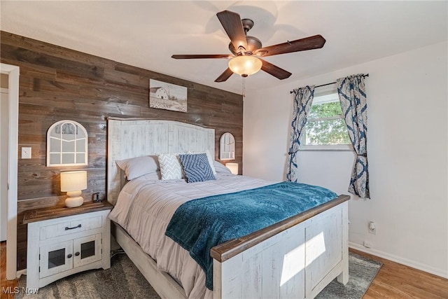 2880 Hetzel Dr, Parma, OH 44134 - bedroom featuring wooden walls, wood finished floors, and a ceiling fan