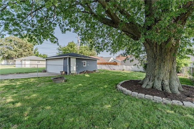 2880 Hetzel Dr, Parma, OH 44134 - view of yard featuring a garage, an outdoor structure, and a fire pit