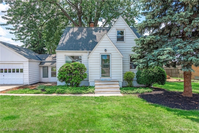 10212 Grace Ave, Garfield Heights, OH 44125 - view of front of property with an attached garage, a chimney, roof with shingles, and entry steps