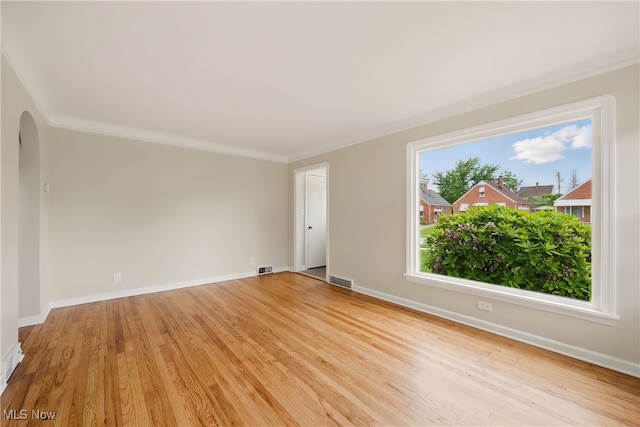 10212 Grace Ave, Garfield Heights, OH 44125 - unfurnished room with arched walkways, light wood-style flooring, and crown molding