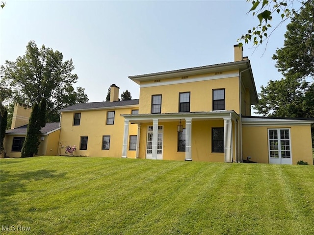 989 Orchard Hill Cir, Massillon, OH 44646 - back of property with a chimney, stucco siding, and a lawn