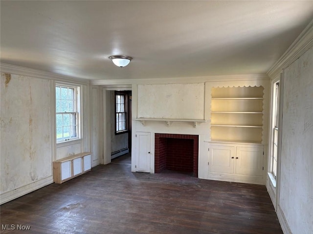 989 Orchard Hill Cir, Massillon, OH 44646 - unfurnished living room featuring a baseboard heating unit, dark wood-style flooring, a fireplace, built in shelves, and crown molding