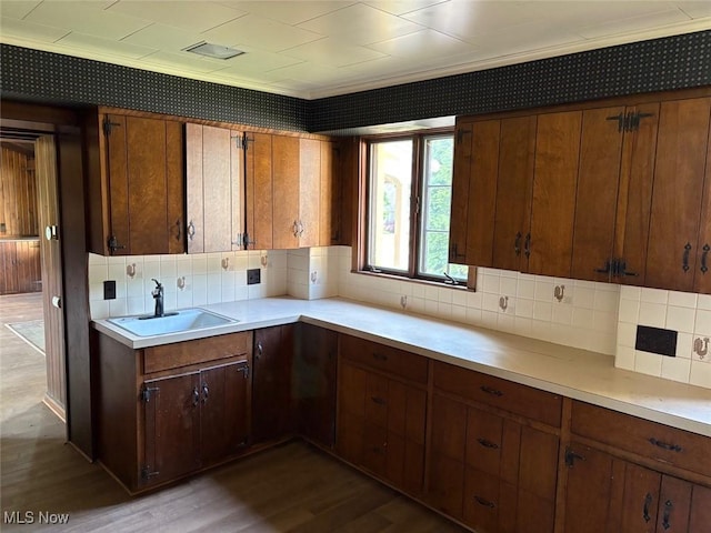 989 Orchard Hill Cir, Massillon, OH 44646 - kitchen featuring backsplash, light countertops, dark wood-style floors, and brown cabinets