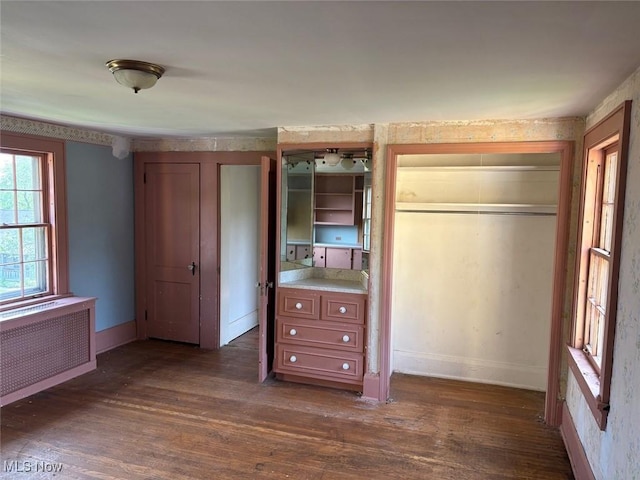989 Orchard Hill Cir, Massillon, OH 44646 - unfurnished bedroom featuring radiator and dark wood-style flooring