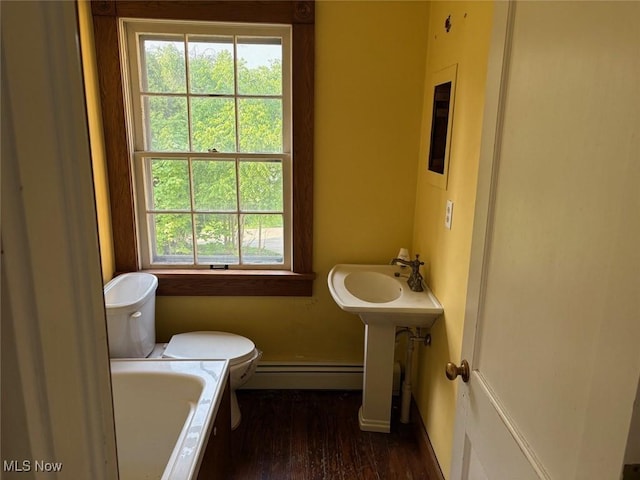 989 Orchard Hill Cir, Massillon, OH 44646 - bathroom featuring a baseboard heating unit, a bath, and wood finished floors