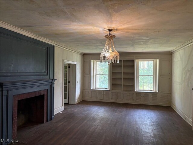 989 Orchard Hill Cir, Massillon, OH 44646 - unfurnished dining area with crown molding, dark wood-style flooring, a fireplace, and a chandelier