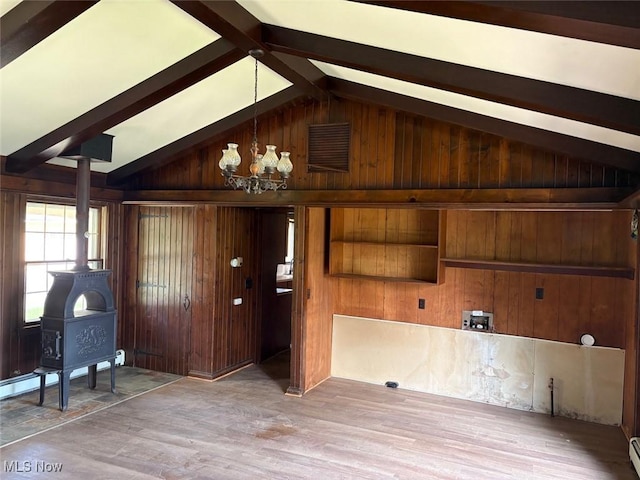 989 Orchard Hill Cir, Massillon, OH 44646 - foyer with a wood stove, wooden walls, wood finished floors, a chandelier, and a baseboard radiator