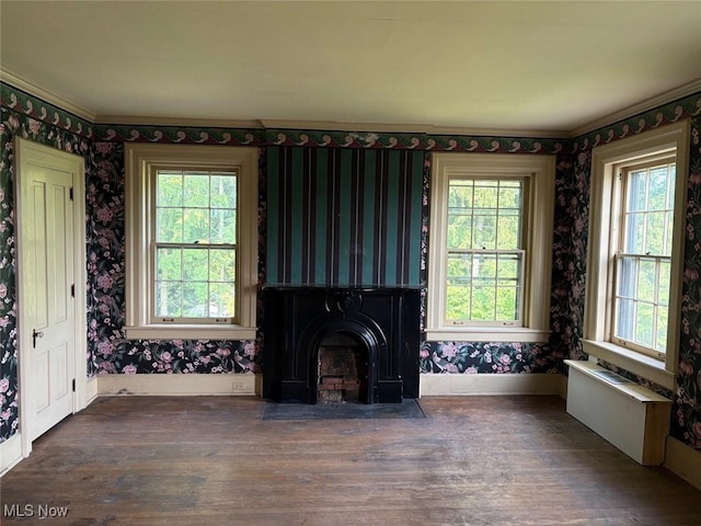 989 Orchard Hill Cir, Massillon, OH 44646 - unfurnished living room featuring wallpapered walls, healthy amount of natural light, wood finished floors, and a fireplace with flush hearth