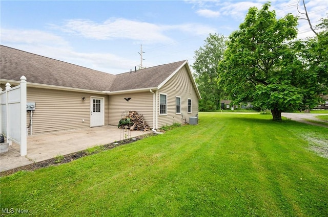 3031 Logan Ln Unit 1, Rock Creek, OH 44084 - back of property with a patio, a lawn, and a shingled roof