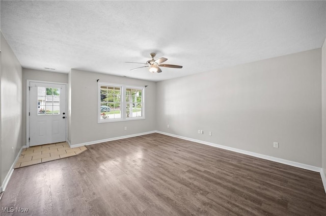 3031 Logan Ln Unit 1, Rock Creek, OH 44084 - foyer featuring wood finished floors, a ceiling fan, and a textured ceiling
