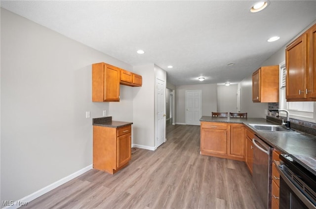 3031 Logan Ln Unit 1, Rock Creek, OH 44084 - kitchen with dishwasher, dark countertops, light wood finished floors, brown cabinets, and recessed lighting