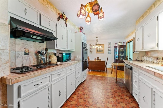 3612 Ridge Rd, Cortland, OH 44410 - kitchen with under cabinet range hood, black appliances, a chandelier, and white cabinets