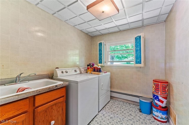 3612 Ridge Rd, Cortland, OH 44410 - laundry room with tile walls, washer and clothes dryer, a baseboard heating unit, and light tile patterned floors