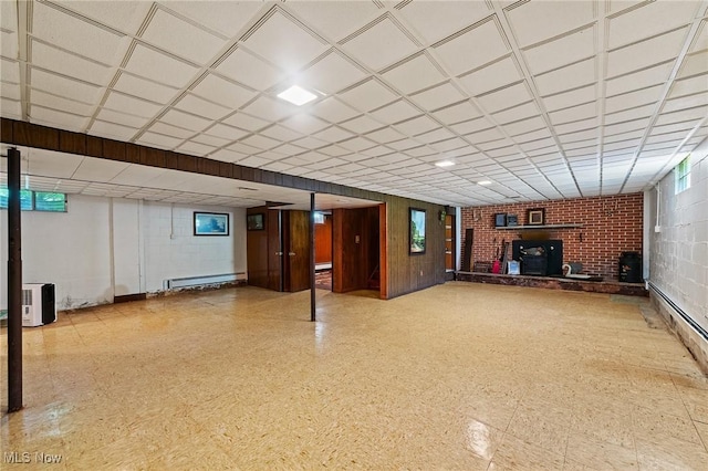 3612 Ridge Rd, Cortland, OH 44410 - basement featuring baseboard heating, a drop ceiling, and a wood stove