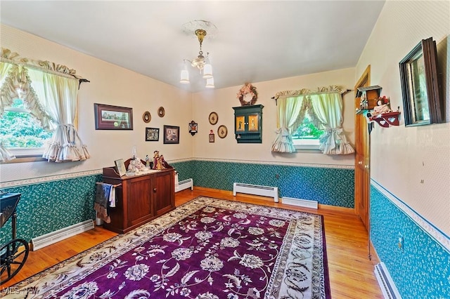 3612 Ridge Rd, Cortland, OH 44410 - office featuring wood finished floors, wallpapered walls, baseboard heating, a wainscoted wall, and a chandelier