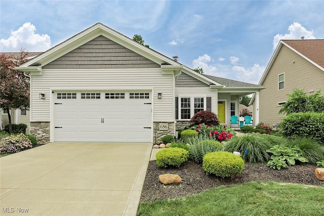 686 Outrigger Cv, Painesville, OH 44077 - view of front of house featuring stone siding, concrete driveway, and an attached garage
